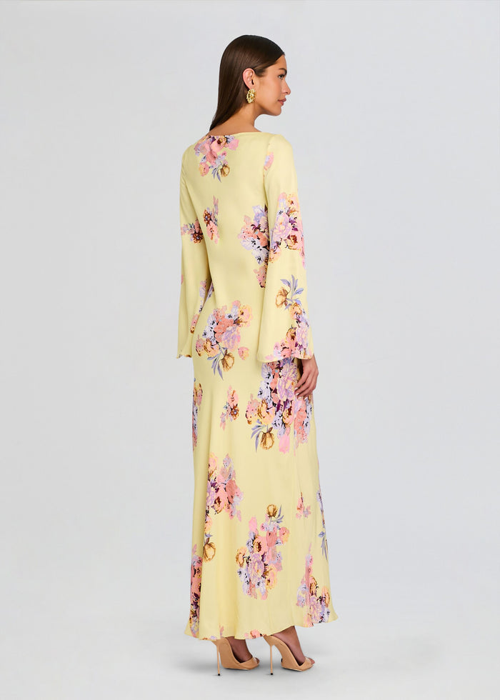 Back view of Kysha Long Bias Dress in pale yellow with pink and lavender floral print, full length maxi. media 4 of 5