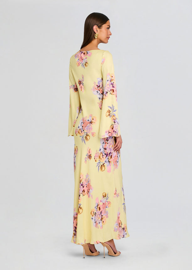 Back view of Kysha Long Bias Dress in pale yellow with pink and lavender floral print, full length maxi.