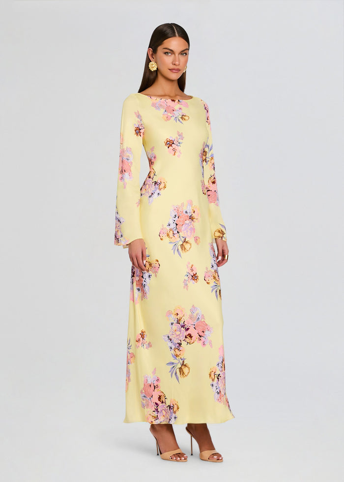 Model wearing a pale yellow floral Kysha Long Bias Dress with long sleeves and full-length silhouette. media 3 of 5