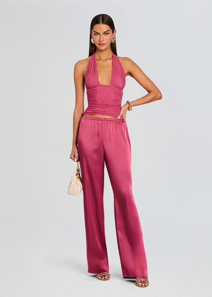 Model wearing a magenta satin halter top and matching wide-leg pants media 2 of 5