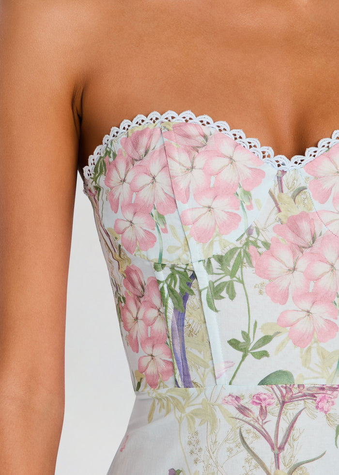 Close-up of the dress bodice showing pink floral print and white lace trim along the top. media 2 of 5