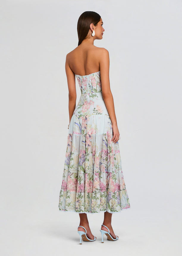 Back view of Danny Long Dress, strapless pastel floral maxi with corset-style bodice and tiered skirt.