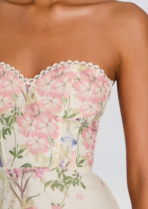 Close-up of a strapless floral dress bodice with white lace trim