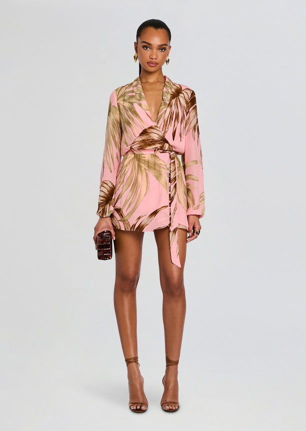 Model in a pink Fawn Mini Dress with Detachable Belt featuring brown palm leaf print wrap silhouette and long sleeves