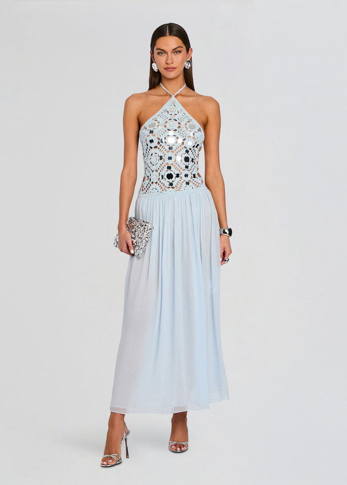 Model in a pale blue crochet halter dress with a lace bodice and flowing skirt. media 1 of 5