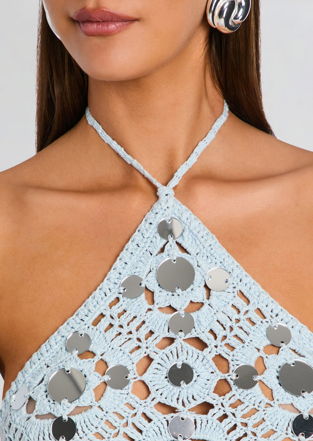 Light blue crochet halter dress bodice with circular silver discs along the front