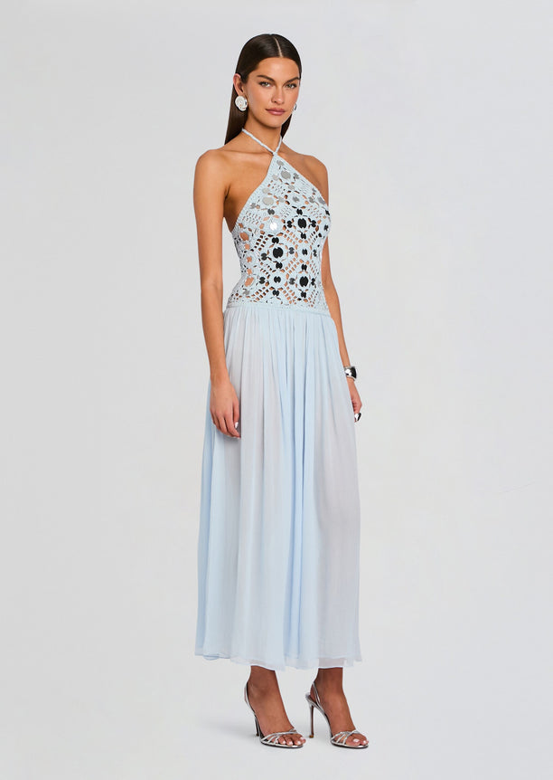 Model wearing light blue crochet halter dress with a fitted crocheted bodice and a long flowing skirt