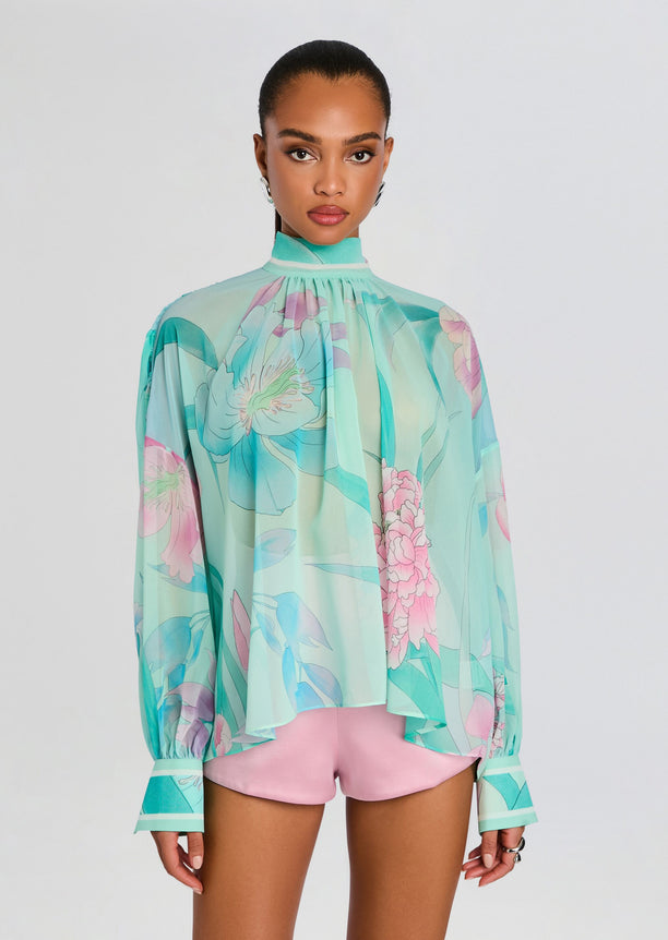 Close up of Olympia Top turquoise floral blouse with gathered high neck and flowing silhouette.