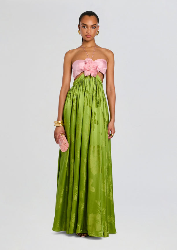 Prudy Dress features a strapless pink bust with a large flower centerpiece and a lime green tropical print flowing skirt.