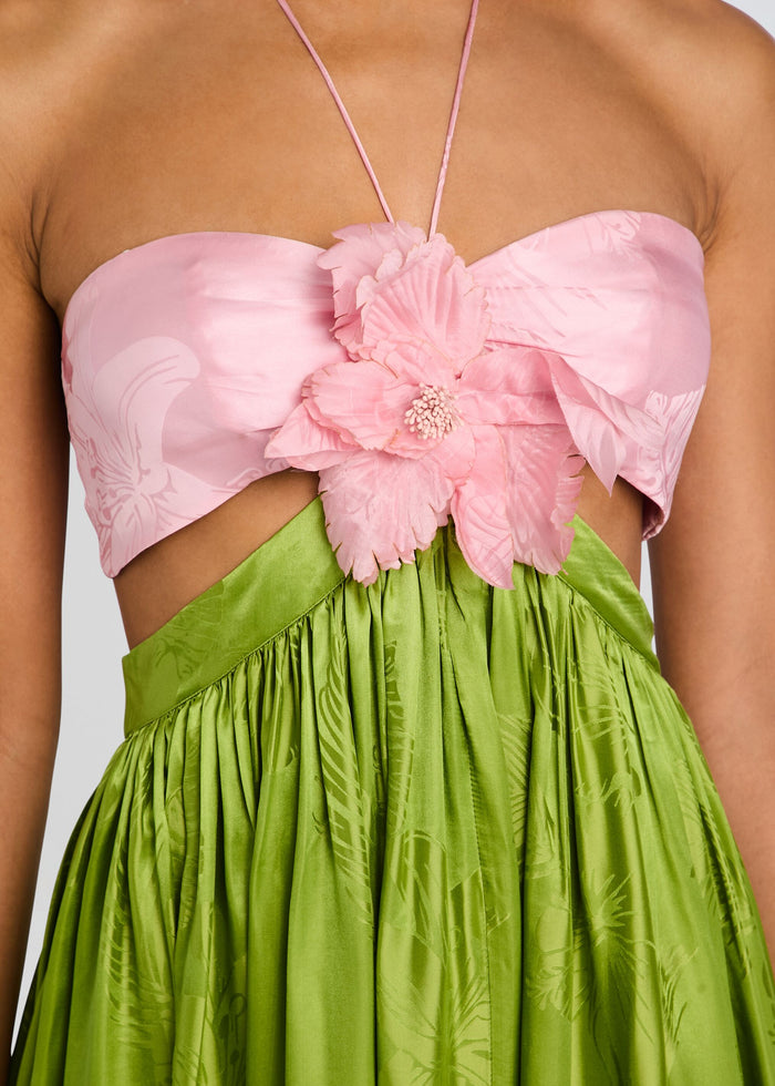 Close-up of Prudy Dress bodice featuring pink strapless top with a large pink flower and a lime green gathered skirt. media 2 of 5