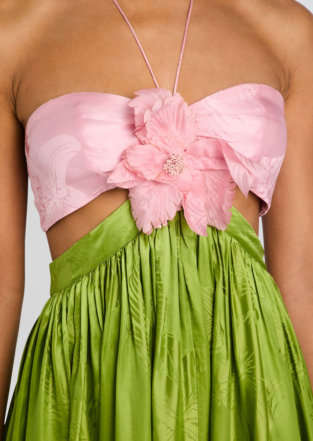 Close-up of Prudy Dress bodice featuring pink strapless top with a large pink flower and a lime green gathered skirt.