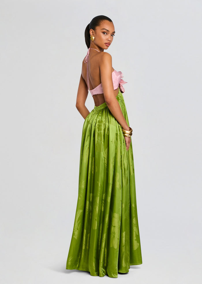 Model in a Prudy Dress with pink top and bright green floral skirt, back view with halter ties media 4 of 5
