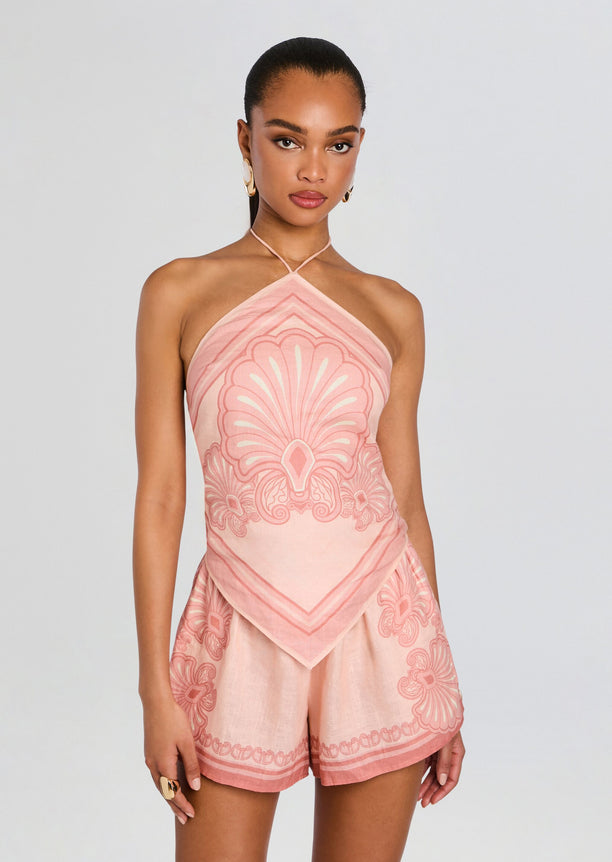 Front view of a model in a pink Rosa Top halter neck with an intricate print