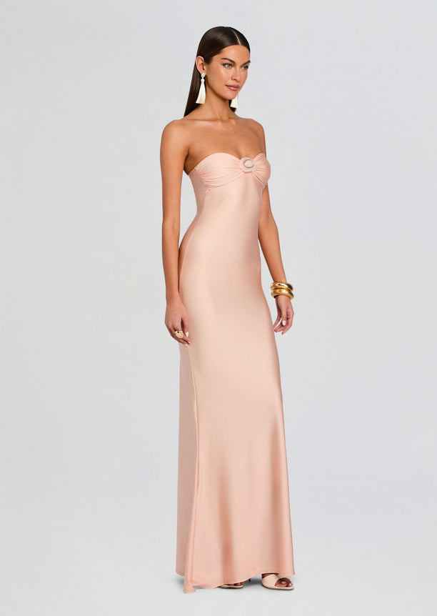 Front view of a blush pink Rose Maxi Dress strapless with a circular ring accent at the bust.