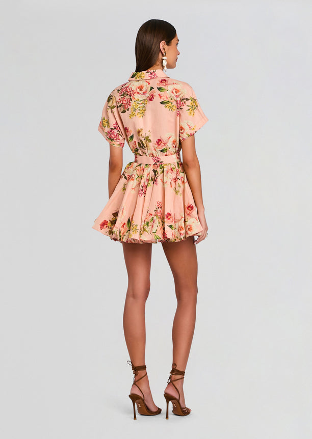 Rear view of model in pink floral Ayla Short Dress With Belt Buckle showing belt and flared skirt
