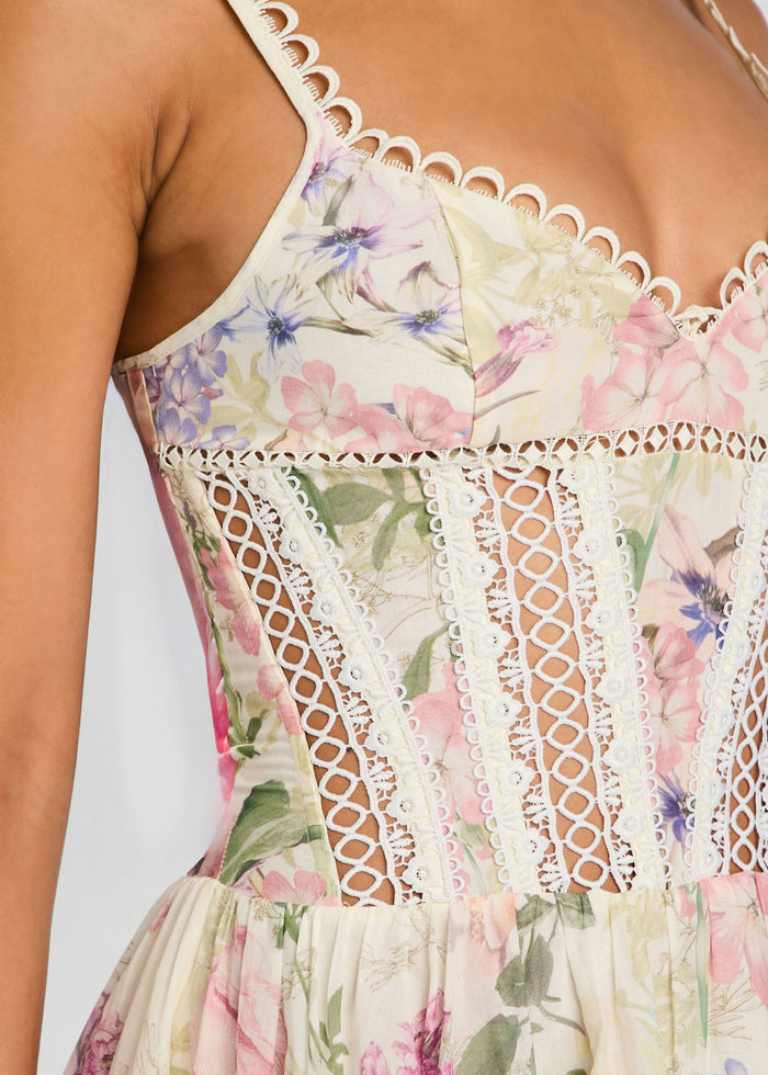 Close-up of the Gardenia Short Dress bodice showing pastel floral print and white intricate lace panels with scalloped trim media 2 of 5