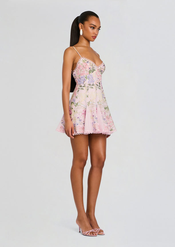 Front view of a model wearing a pink floral Marlene Short Dress with lace trim and spaghetti straps.