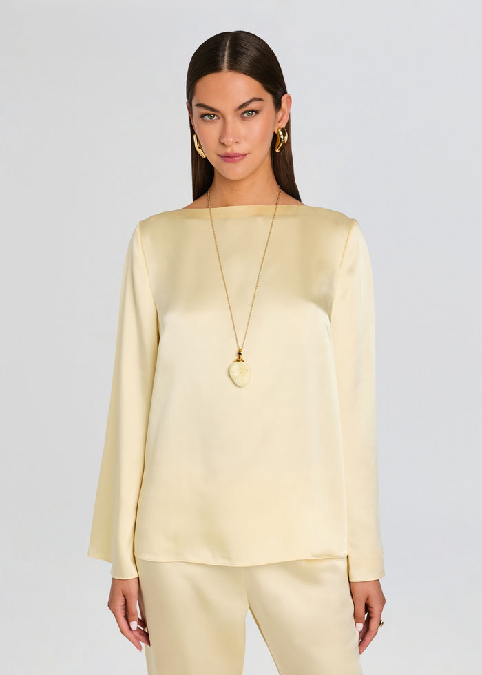 Model wearing a pale yellow satin Blaine Blouse with matching satin pants. media 1 of 5