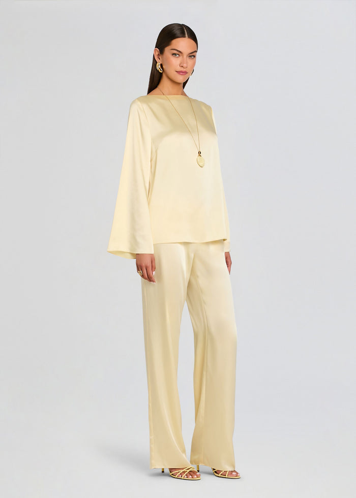 Close-up of the Blaine blouse sleeve with a flared cuff and a hand wearing a gold ring. media 4 of 5