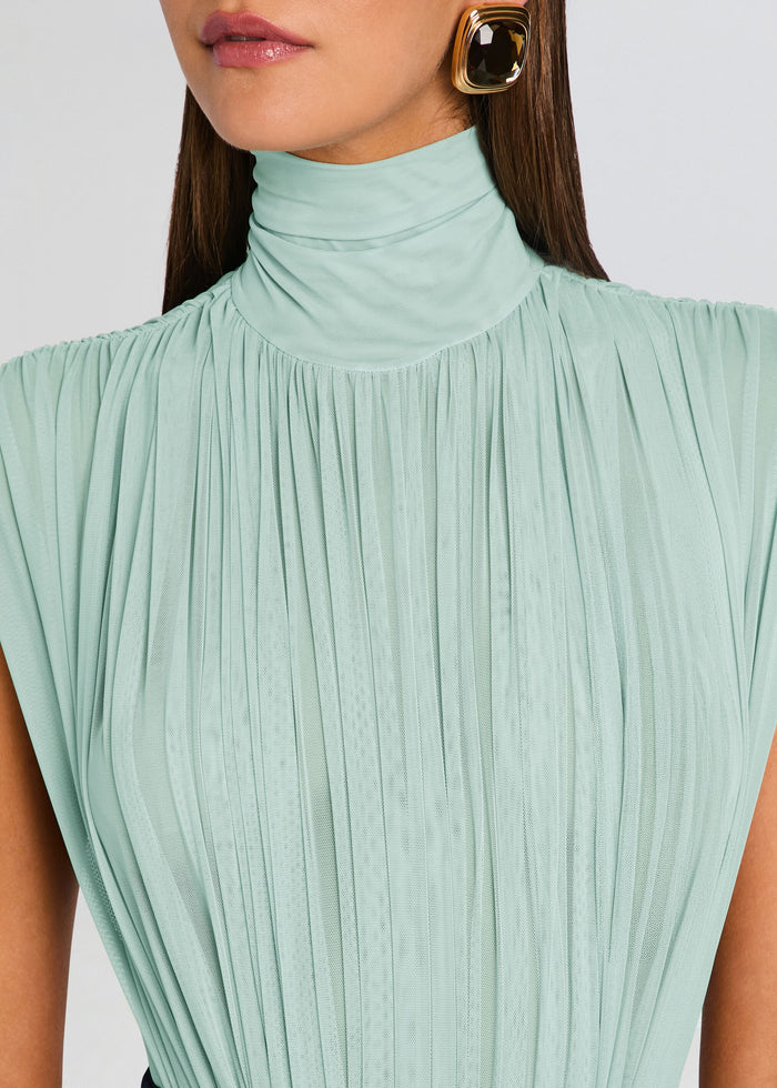 Close-up of mint pleated high-neck top showing textured fabric and soft draping. media 3 of 5