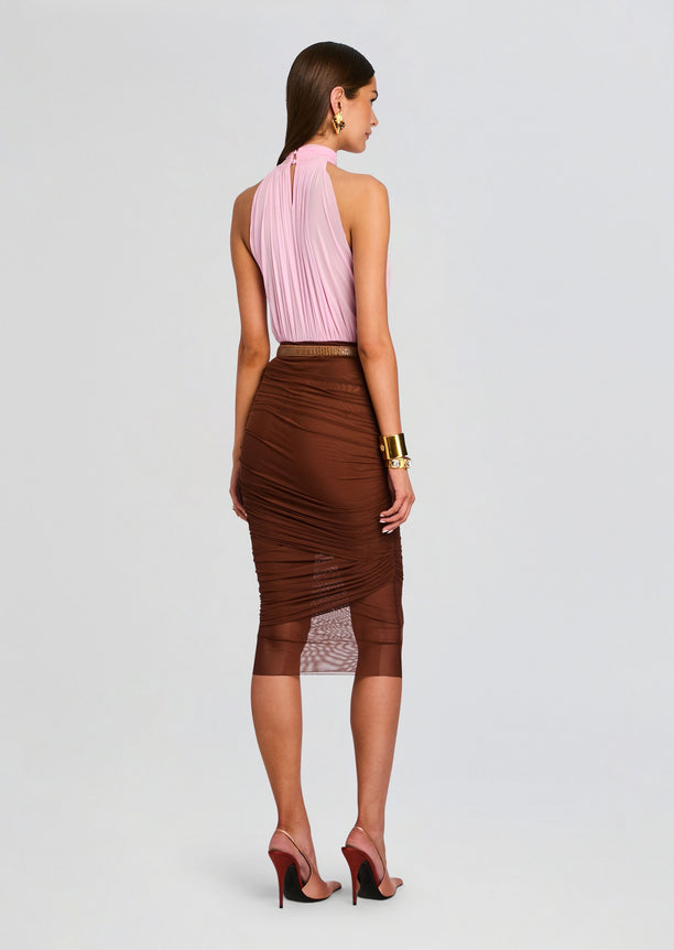 Back view of model in pink halter neck bodysuit and brown ruched midi skirt with belt.