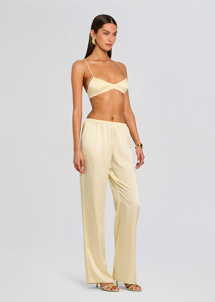 Model wearing pale yellow satin Courtney Bralette with matching wide-leg satin pants. media 4 of 5
