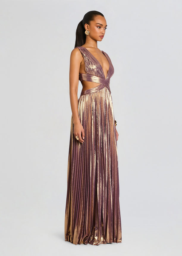 Model wearing Dracey Dress in a floor-length metallic mauve pleated gown with a wrap waist and plunging neckline.