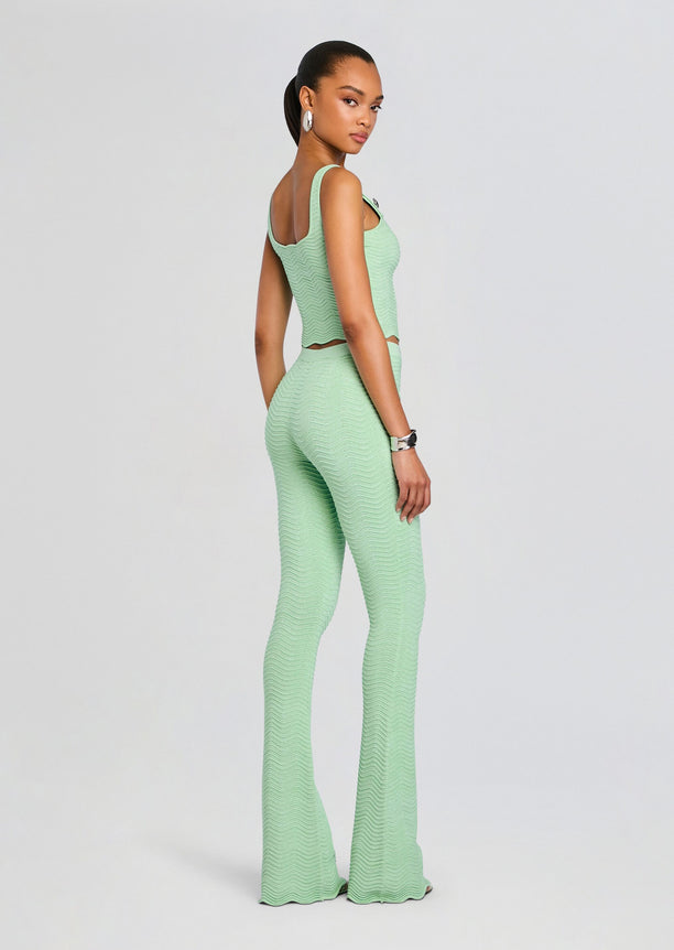 Back view of mint green rib knit crop top and matching high-waisted pants on a model