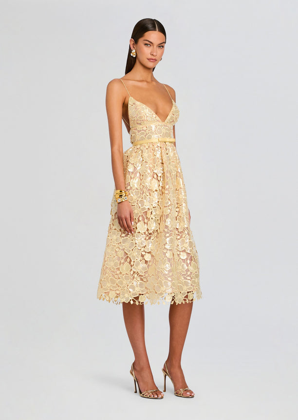 Full-length view of a champagne gold floral lace Eulalia dress with spaghetti straps and a midi skirt.