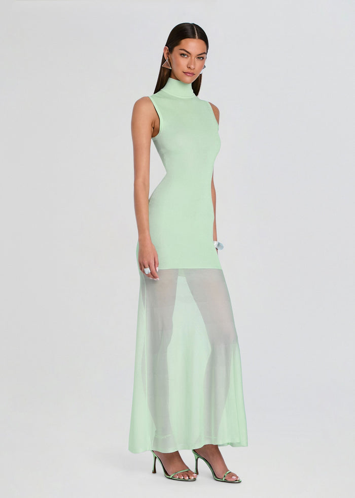 Model wearing mint green sleeveless knit maxi dress with high neckline and sheer mesh skirt panel media 3 of 5