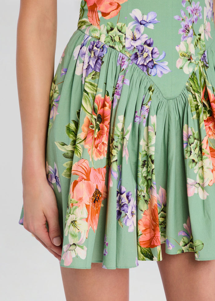 Close-up of the Cove Corseted Mini Dress skirt showing green floral print and a gathered waist. media 2 of 5