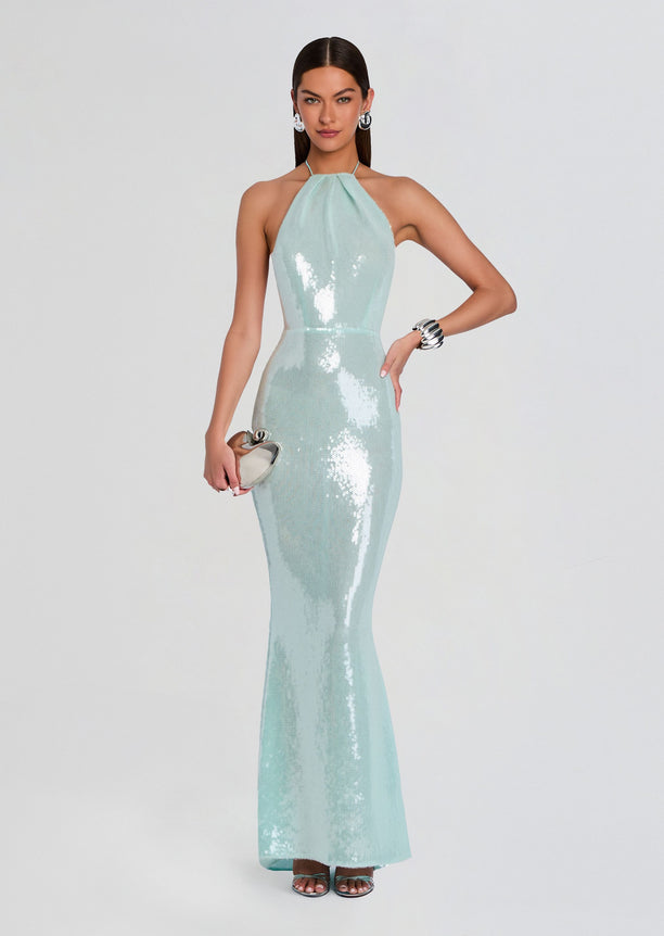 Model wearing Elexa Sequin Dress mint halter neck floor-length gown with a fitted silhouette and silver clutch.