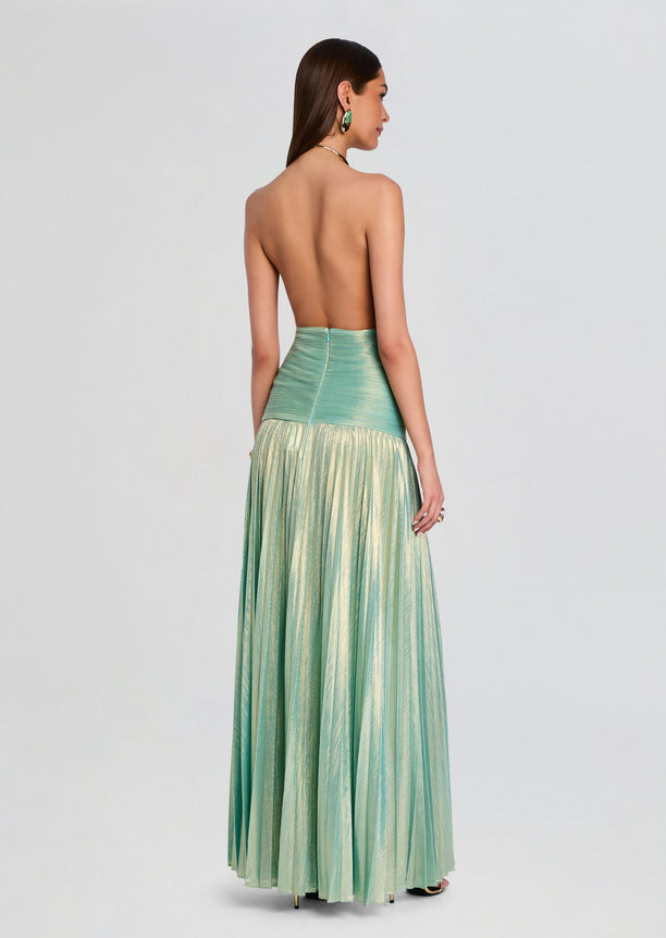 Back view of Faelina Dress in mint green with ruched waist and flowing metallic pleated skirt
