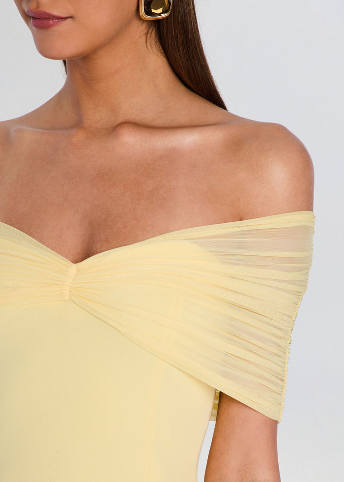 Close-up of the off-shoulder neckline showing pleated sheer sleeve detail on the pale yellow dress. media 2 of 5