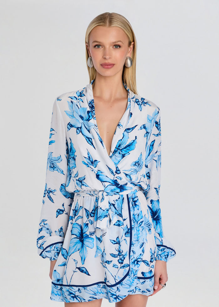 Front view of Milo mini dress with detachable belt in blue floral print featuring wrap bodice and long sleeves. media 5 of 5