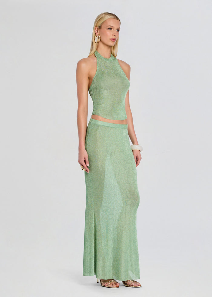 Side view of a model wearing the Harmony Metallic Knit Skirt set with mint halter top and long skirt media 4 of 5