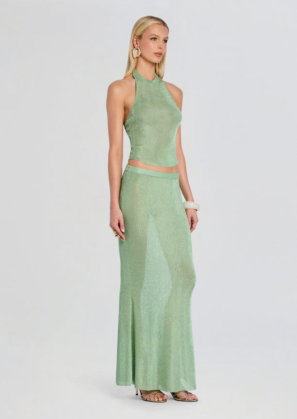 Model wearing Minnie Metallic Knit Halter Top with a matching floor-length skirt in mint green.