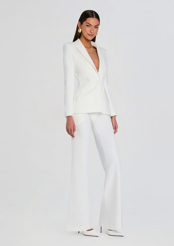 Model wearing white pin tuck palazzo pants with matching blazer