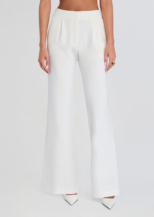 Front view of white pin tuck palazzo pants with a high waist and wide legs.