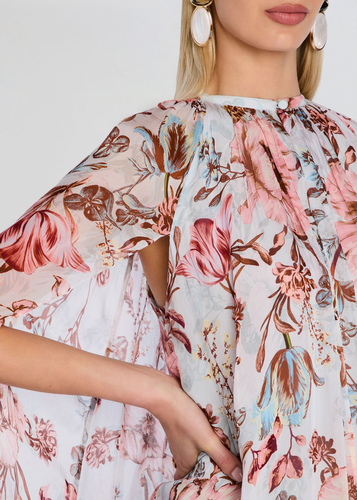 Close up of pink floral Ezra Ruched Cape Mini Dress fabric with gathered neckline and draped cape sleeve media 2 of 5