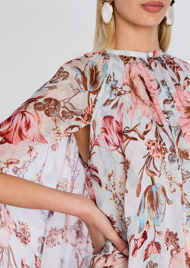 Close up of pink floral Ezra Ruched Cape Mini Dress fabric with gathered neckline and draped cape sleeve