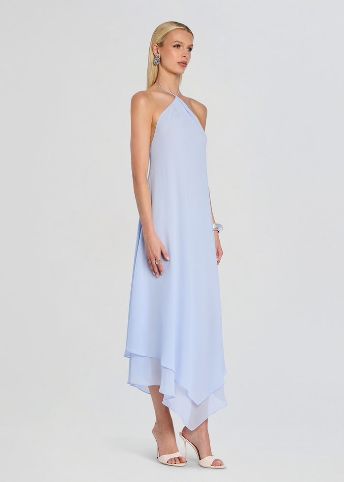Sally Maxi Dress in light blue shown from the side with an asymmetric layered hem and nude heels. media 3 of 5