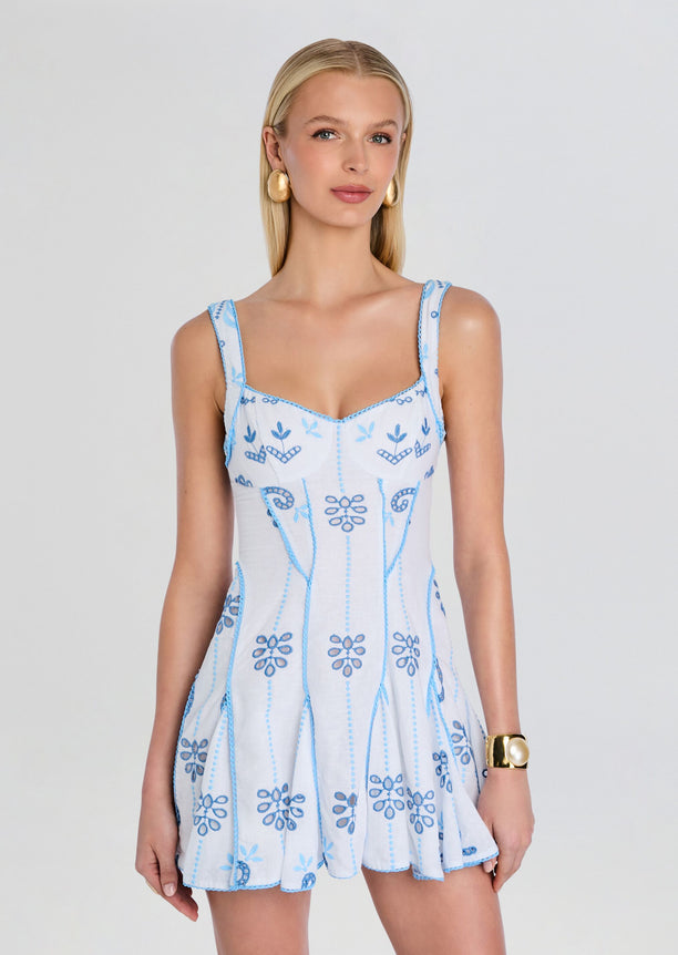 Front view of Arissa Short Dress in light blue with embroidered floral pattern and slim straps.