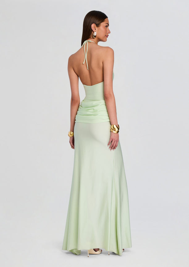 Back view of mint green Valentine Maxi Dress showing halter tie open back and draped ruched waist into a floor length skirt.