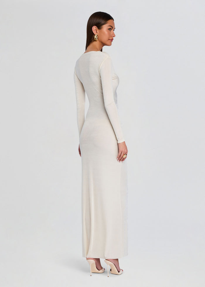 Side view of a cream Ebony Maxi Dress on a model with long sleeves and a fitted floor-length silhouette. media 4 of 5