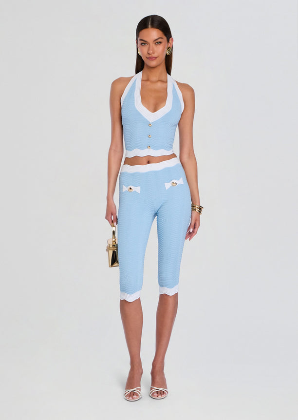 Light blue rib knit halter top with white trim and front gold buttons