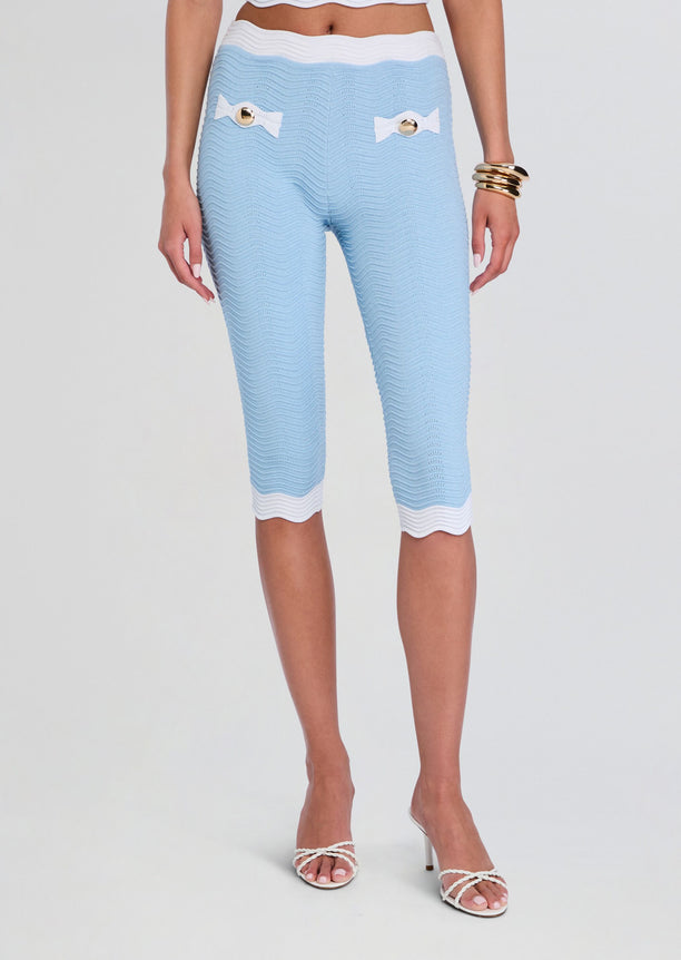 Light blue rib knit knee-length pants with white trim and bow pocket accents
