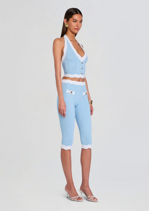 Model wearing Leena Rib Knit Top a light blue cropped halter with white trim and front button detailing