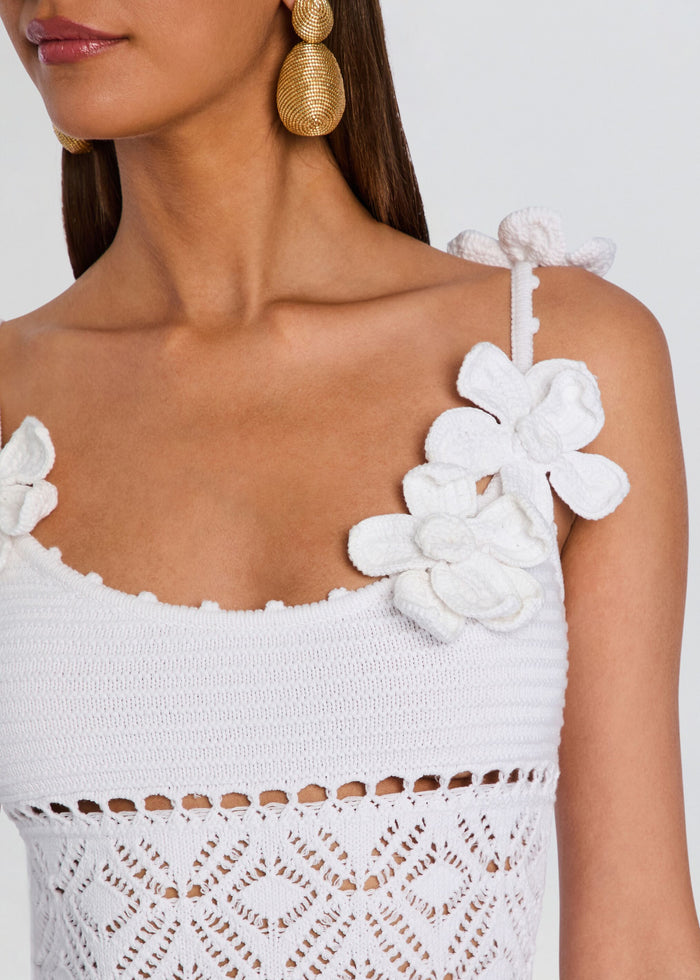 Close-up of the Orleane Crochet Dress shoulder with white flower applique and textured strap. media 2 of 5