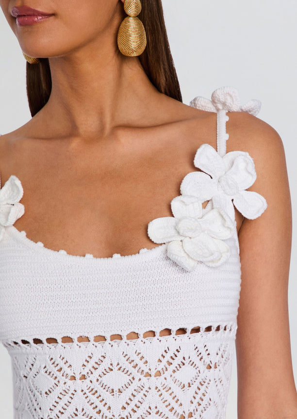 Close-up of the Orleane Crochet Dress shoulder with white flower applique and textured strap.